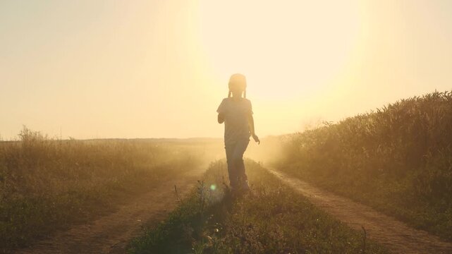 children dream superhero flight, little happy girl runs along country road sunset, girl runs along wheat field sunset, baby child kid runs along wheat field, kid plays sunset runs with his feet, happy