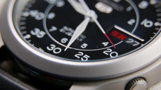 Close up of a fully automatic military watch with ticking hands
