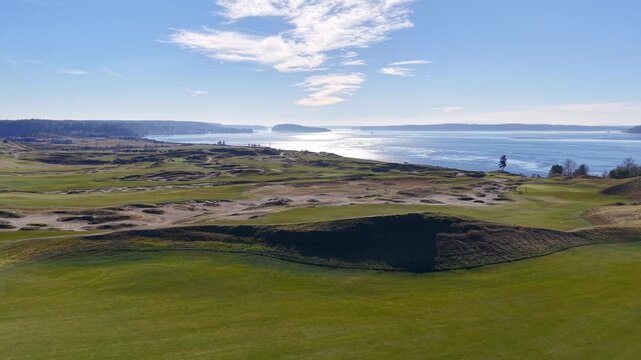 Cinematic aerial drone view of Chambers Bay golf course along the Puget Sound in Washington