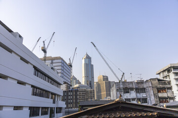 Fototapeta premium Energetic urban city undergoing rapid construction and development, with tall crane building modern skyscraper, blending fresh architecture into dynamic skyline for bustling view