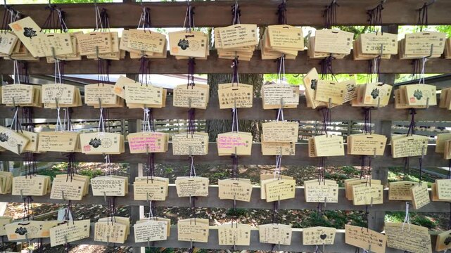 Meiji-jingu temple with wooden ema plaques displaying handwritten wishes and prayers
