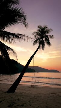 Experience the serene beauty of Koh Kood as palm trees sway gently by the shore. The vibrant sunset casts a warm glow over the calm waters, creating a picturesque holiday escape.