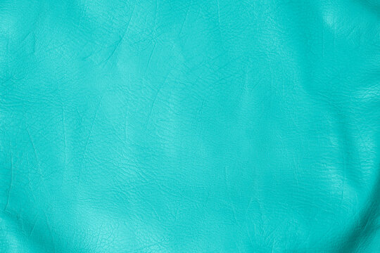 Detailed vibrant teal aqua leather texture background showing natural creases and soft surface