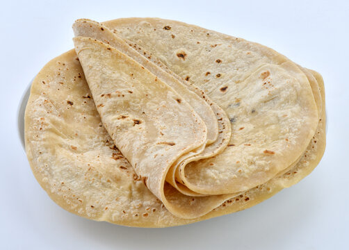 Fresh folded chapatis stacked neatly on a serving plate