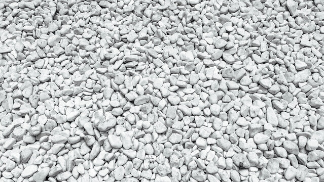 Close up view of numerous small white decorative stones creating a detailed natural background texture