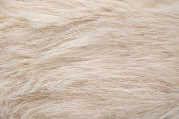 Luxurious fluffy light beige fabric background showing soft cozy warm fur texture material pattern © reddish