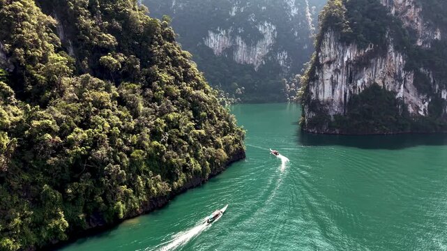 Discover the serene beauty of Khao Sok National Park in Thailand, where emerald waters meet stunning limestone cliffs. Experience natures tranquility in this tropical paradise.