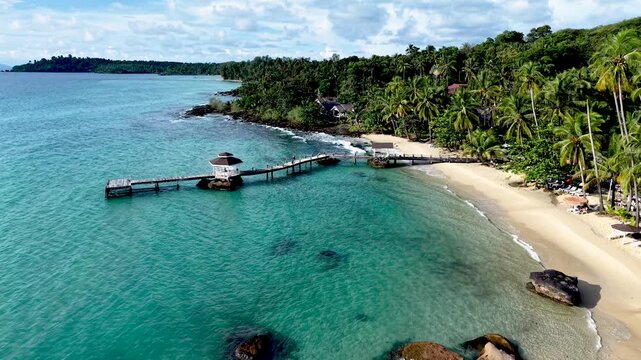 Experience the breathtaking beauty of Koh Kood Island in Thailand, featuring crystal-clear waters, lush palm trees, and serene sandy beaches.