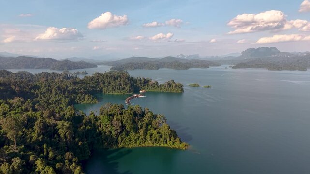 Witness stunning aerial views of Khao Sok, Thailand, showcasing tranquil waters surrounded by towering trees. Ideal spot for nature lovers seeking adventure and tranquility.