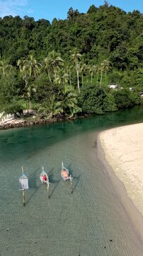 Discover the tranquil beauty of Koh Kood Island in Thailand, where hammocks sway gently above clear waters, offering the perfect escape to unwind, A couple of men and women on vacation in Thailand