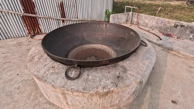 A big cast-iron pan or kadai for cooking food for visitors.