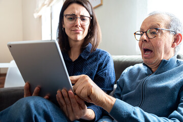Senior man and woman discovering new digital tablet content