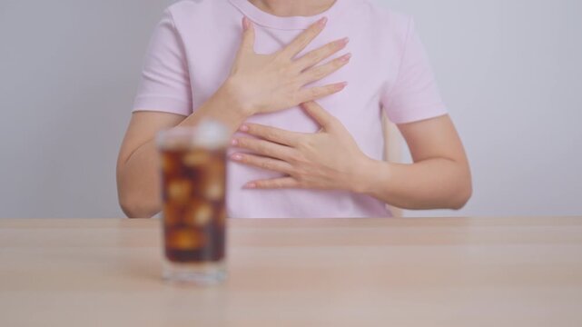 Woman hand stop and refuse gesture to carbonated soft drink, feeling Abdominal pain after drinking soda water, bloating and gas in digestive system, stomach ache, Acid reflux, Heartburn and Gastritis