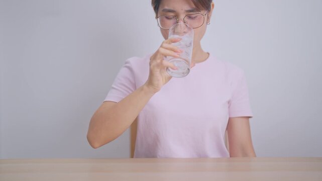 woman having toothache and pain after drink ice water for concept of Teeth Sensitive to Cold, Tooth Decay and Gum Disease, Grinding Teeth and Stress, Exposed Nerve Roots, Crack and Receding