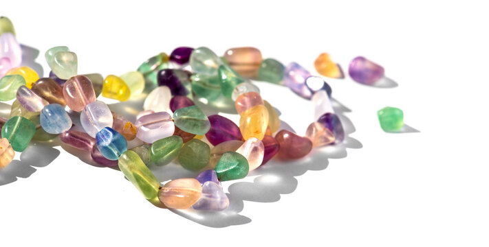 Fluorite natural colorful stones, mineral, beads of bracelet, necklace isolated on white background. Fluorspar stone gems, set of natural mineral stones, beautiful gemstones border design 