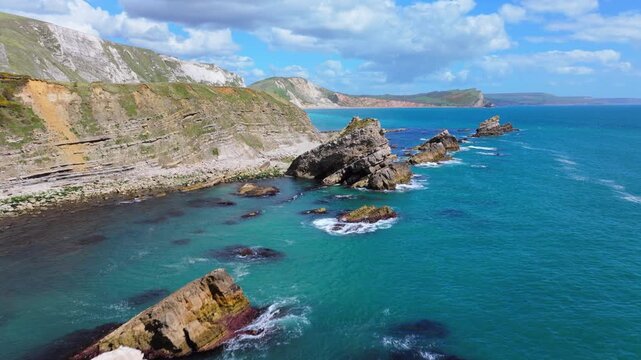 Aerial shot flying over rocky coastline near Lulworth Cove, Dorset