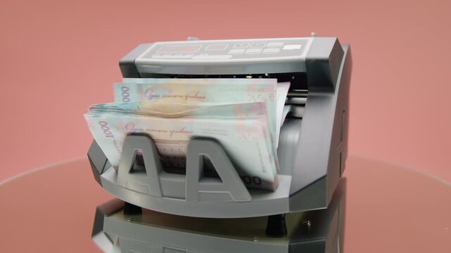 Money counting machine with Ukrainian banknotes