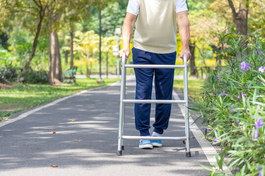 elderly man legs walking with walker aid in the park ,concept senior lifestyle,exercise,rehabilitation