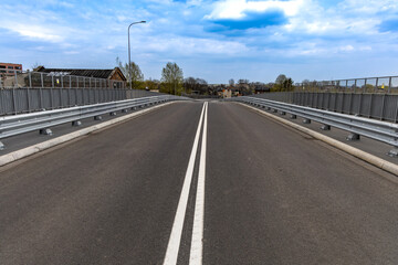 Construction of a new bridge in Częstochowa, the Jacek Magiera Viaduct, an asphalt road over the railway tracks, a road investment to improve urban traffic, an empty road in the city center, acceptanc © dominikspalek.pl