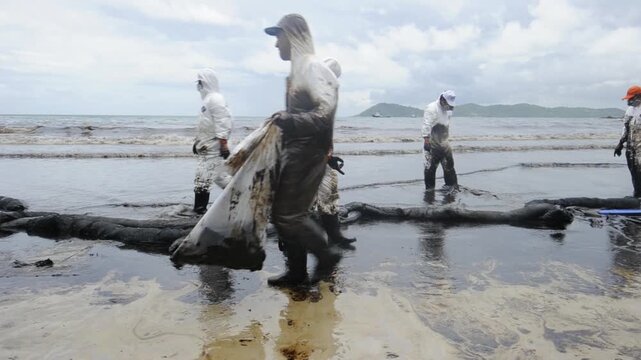 Petroleum spill mixed with other chemical substances on sea and sand surface. Pollution footages, Samet Island, Thailand.
