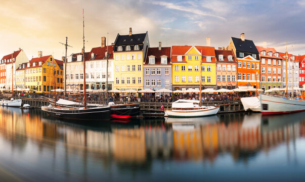 Copenhagen colored building in Nyhavn with blue sky and sun, Denmark