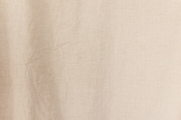 Fototapeta premium Detailed texture of natural beige linen fabric with soft wrinkles.