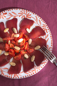 La moixama. Mojama, spanish dried tuna served with tomatoes, almonds, and olive oil. A gourmet dried fish
