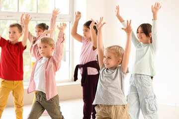 Fototapeta na wymiar Group of cute little children dancing in studio