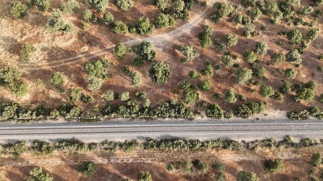 Drone flying forward revealing old railway track and reaching top view