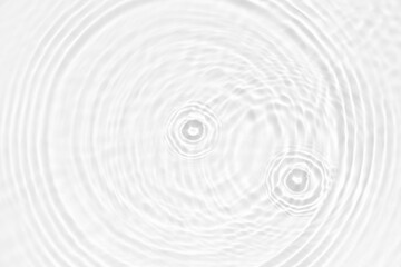 Obraz premium White water with ripples on the surface. Defocus blurred transparent white colored clear calm water surface texture with splashes and bubbles. Water waves with shining pattern texture background.