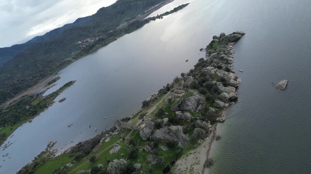 Drone footage captures the stunning natural beauty and historical significance of Bafa Lake Nature Park in Turkey. The aerial perspective showcases the serene waters of Bafa Lake nestled amidst rugged