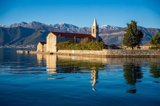 View of Our Lady of Mercy Island from yacht boat near Tivat city in Kotor bay of Adriatic sea in Montenegro in winter time