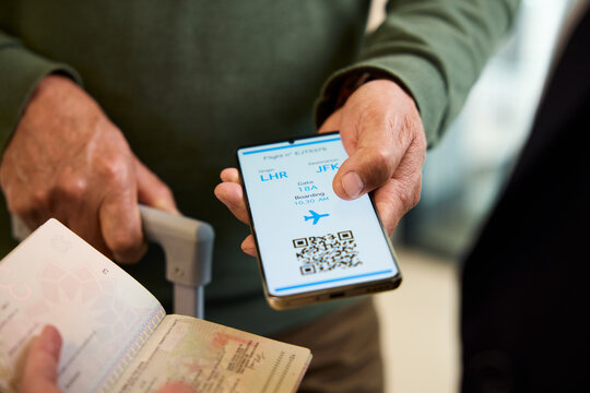 Man showing digital flight e-ticket before departure