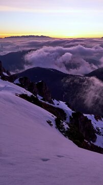 Vertical alpine winter sunrise and cloud sea pan