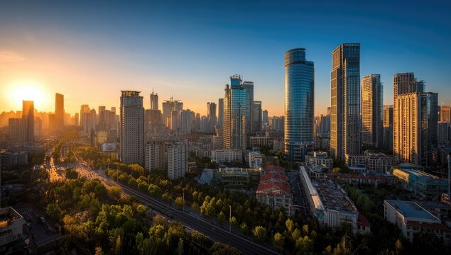 A stunning aerial view captures a modern cityscape bathed in the warm glow of a setting sun, showcasing towering skyscrapers and sprawling urban infrastructure.