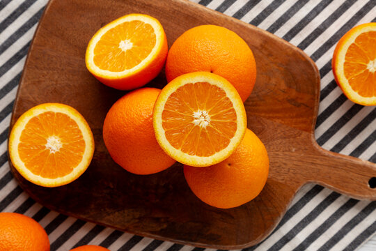 Raw Organic Oranges on a Wooden Board, top view. Flat lay, overhead.