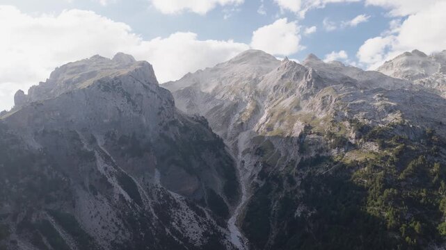 Aerial view of rugged mountains with a dusting of clouds, creating a dramatic contrast between the rock and the sky, Teth, Shkoder County, Albania.