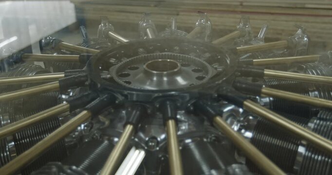 Close up of a vintage radial aircraft engine with steam or smoke rising from the cylinders