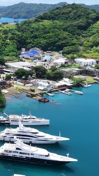 Aerial View of Superyachts in Palau Harbor with Tropical Island Background