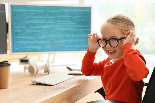 Cute little programmer girl in office