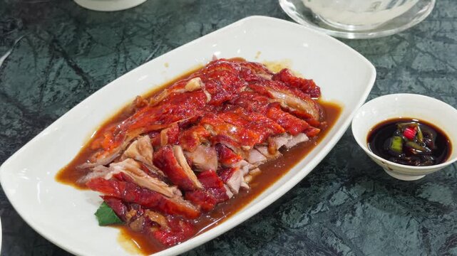 Thai Chinese Roast Duck Plate with Red Chili Sauce Poured - Crispy Sliced Duck Dipping Sauce Restaurant Dish