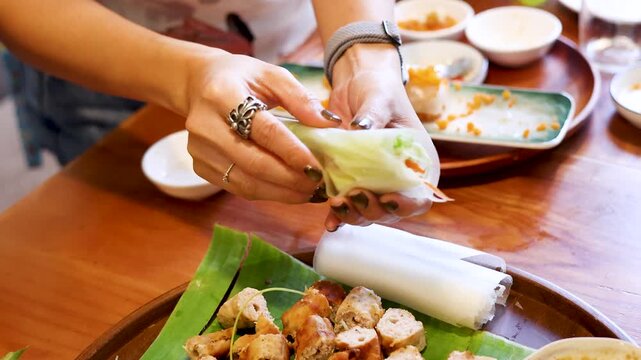 Vietnamese Woman Hands Rolling Fresh Spring Roll with Rice Paper