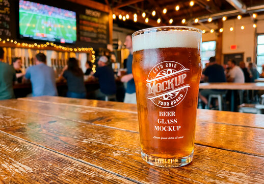 Glass of craft beer on wooden table in bar environment