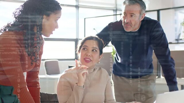 Seated woman pointing at laptop, colleague gesturing causing binary overlay showing business data