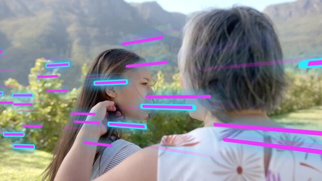 Mother lifting hand, smoothing teen hair as magenta cyan streaks overlaying, prepping ad