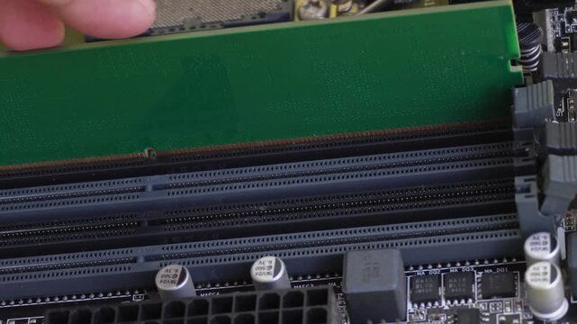A close-up of the RAM (Random Access Memory) installation on a computer motherboard. RAM is a hardware component on a computer.
