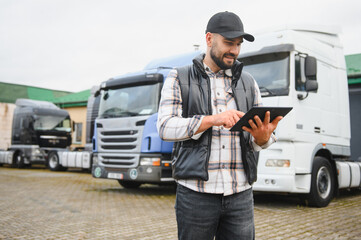 Truck driver using tablet for logistics management © Serhii