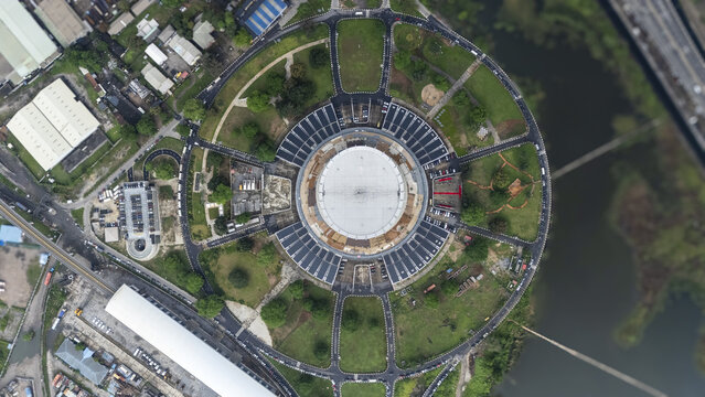 Aerial view of the National Theatre, a circular cultural landmark surrounded by green spaces and water, shining under the sun, Lagos, Lagos, Nigeria.