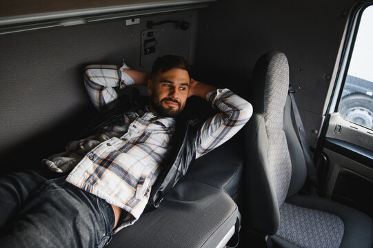 Truck driver resting inside sleeper cab during break