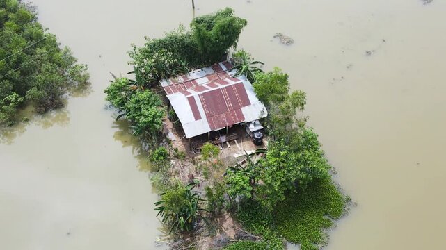 Flood water surround a house, showing of natural disaster. Drone view.